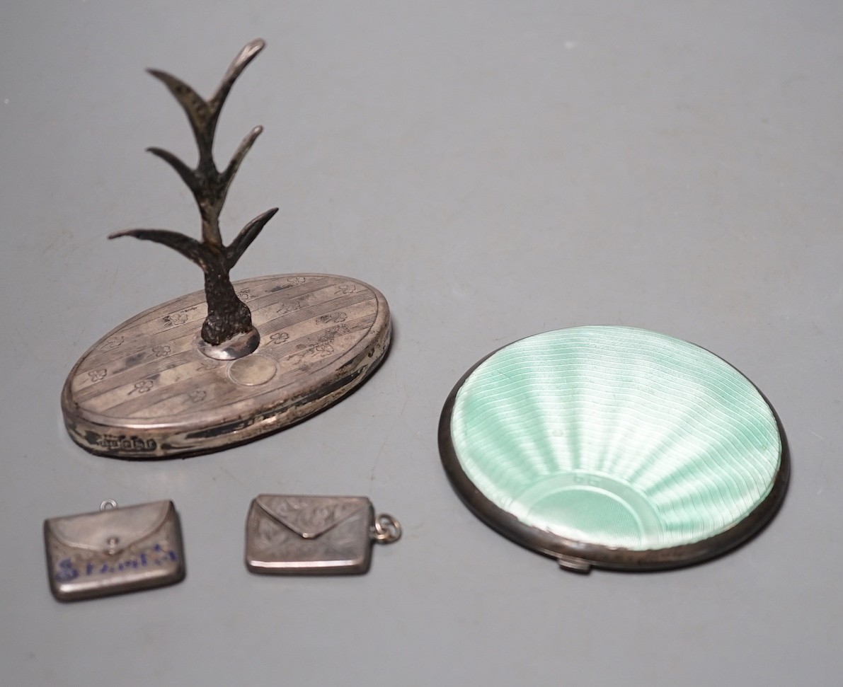 A 1930' silver and green enamel mounted compact, a silver mounted ring tree and two early 20th century silver 'envelope' stamp cases, one with enamel.